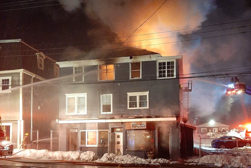 Flames shoot through the roof of 413 Charlotte St. on Saturday as firefighters tried to battle the blaze. Home to some businesses and apartments, the fire had to be attacked from outside by demolishing the building. CONTRIBUTED/Donald Calabrese
