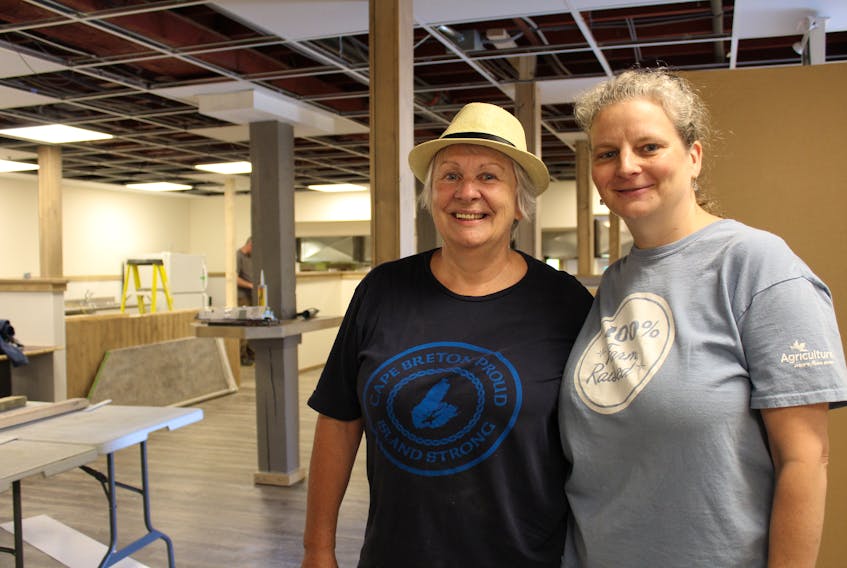 Cape Breton Farmers’ Market manager Pauline Singer, right, and craft vendor Diane MacLean, who is a former market co-manager with Singer, are eagerly anticipating the end of renovations to the new location of the market at 15 Falmouth St. in Sydney. Construction at the site began in June 2018 and has been forced to deal with several delays and hurdles associated with revamping the former Smooth Hermans cabaret into the farmers’ market.