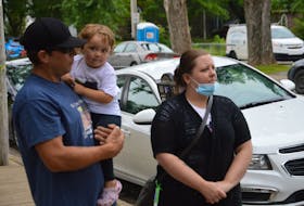 Nathan Joneil Hanna’s stepfather, Steven Penney, left, Joneil’s two-year-old daughter, Harper, and his mother, Jen, wait to speak with reporters Wednesday outside the Sydney Justice Centre. The family offered their reaction to the withdrawal of an obstruction charge filed against a Bras d’Or man in connection with Joneil’s death in 2018.
