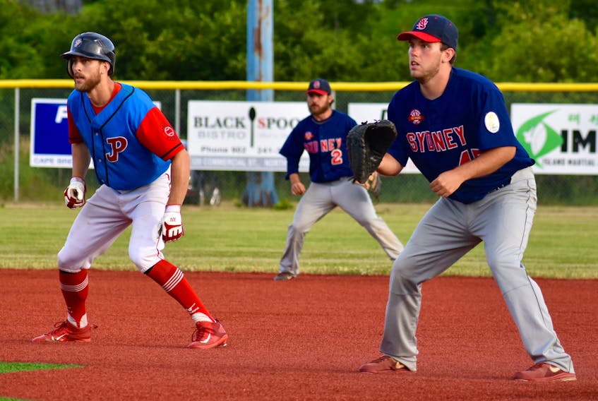 In this file photo, Kenny Long, right, of the Sydney Sooners holds Steve Murphy of the Halifax Pelham Molson Canadians at first base during a Nova Scotia Senior Baseball League game at the Susan McEachern Memorial Ball Park earlier this month. The Sooners will host the Canadians in a two-game series, beginning Friday in Sydney.