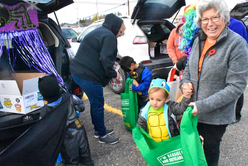 Laurie Doucette walked her grandson, Stefan Helle, nearly 3, around while he picked up goodies from the trucks of vehicles set up outside the Membertou Daycare. The ‘Trick-or-Trunk’ event was started last year to make an annual Halloween tradition safer for local preschoolers.