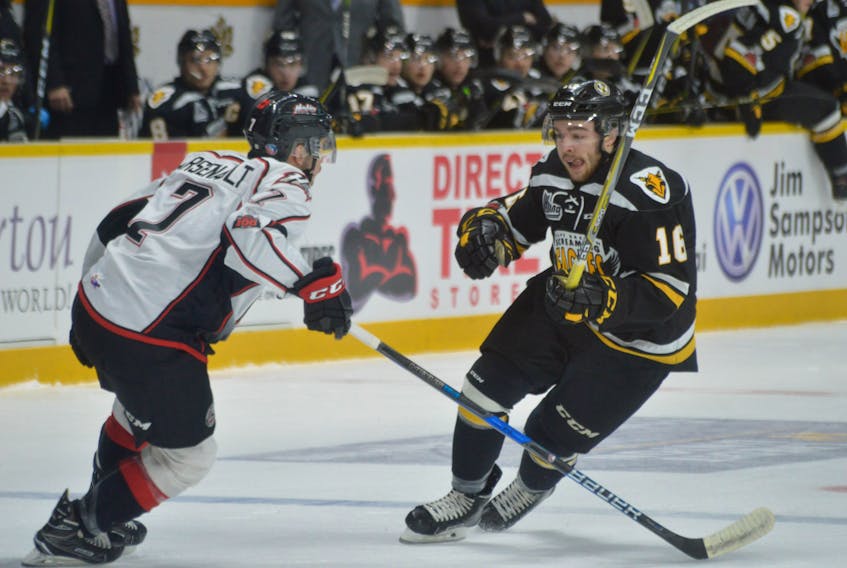 Kyle McGrath of the Cape Breton Screaming Eagles, right, looks to get around Alexis Arsenault of the Rouyn-Noranda Huskies. T.J. COLELLO