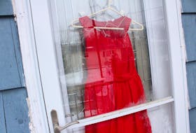 Several red dresses could be seen hanging in windows and doorways around the First Nation community of Membertou on Thursday.
