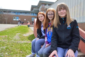 Grade 7 students of Breton Education Centre in New Waterford, from left, Taylor Wilson, Courtney Kelly and Jorja McPhee, relax in front of the school. The girls all were all happy to hear the news of major renovations slated for BEC. The Department of Education announced 13 projects of new builds or major renovations to schools across in the province over the next five years.
