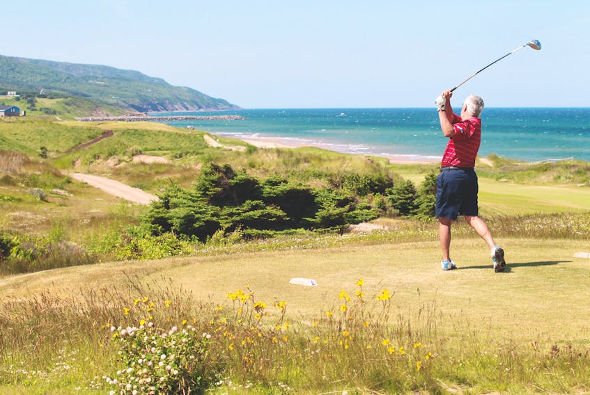 A golfer enjoys a scenic view while he tees off at the Cabot Links golf course in Inverness in this file photo. Cabot Links has officially announced the opening of a public access trail to Inverness beach, located at the north end of the popular attraction.