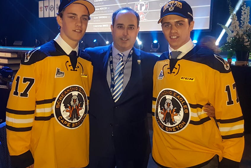 The Cape Breton Screaming Eagles selected forward Brooklyn Kalmikov, left, and defenceman Noah Laaouan in the first round of last year’s Quebec Major Junior Hockey League draft in Saint John, N.B. They’re shown with head coach and general manager Marc-André Dumont.