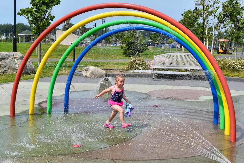 Lilah McCarthy enjoys a splash through the water fountains at the children’s playground at Sydney’s Open Hearth Park on Tuesday. Lilah and mom Shyella were among the first arrivals at the popular summer kid’s place on what turned out to be the hottest day of the summer. Local temperatures reached 31 C with the humidity making it feel more like 39 C.