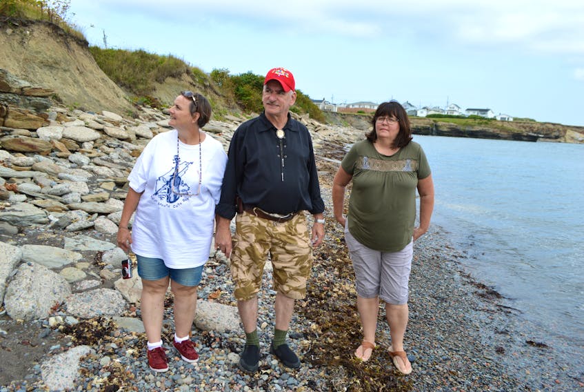 Edgard Fuss, centre, of Overhoffen-sur-Moder, France, walks along the coastline at the end of Ocean Street in Glace Bay with his wife Ute Fuss, left, and Cathy Murphy MacDonald, of Port Hawkesbury, near an area where MacDonald’s late uncle David Matthew Murphy, a flight sergeant in the Royal Air Force who died in the Second World War at age 20, would have frequented as a child. Fuss found David’s gravesite in a local cemetery in Montoir-De-Bretagne, France. He felt and bad that the airman was buried alone instead of in a memorial cemetery with his crew, so he did research to find out why and ended up having a plaque made and erected at the cemetery, resulting in the families later connecting.