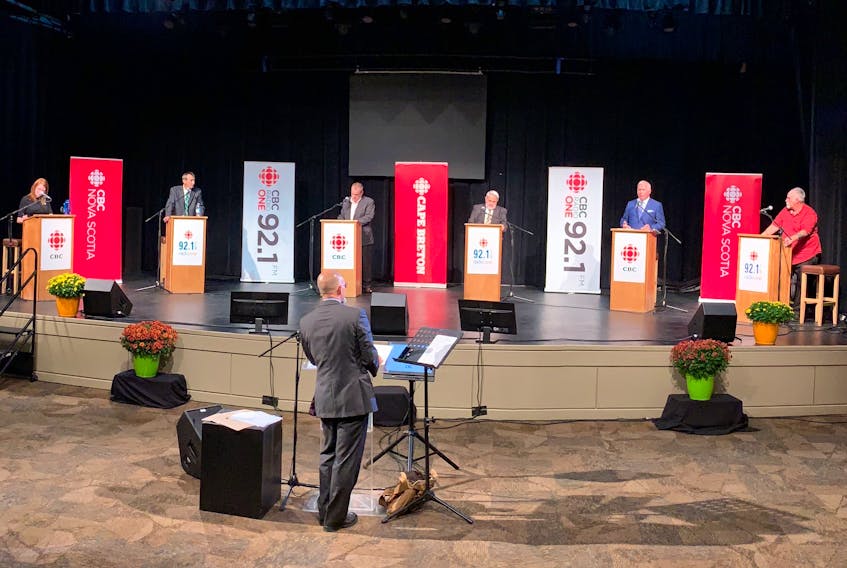 The six candidates vying to be the next mayor of the CBRM took part in a two-hour forum on Wednesday evening at the Membertou Trade and Convention Centre. The event was hosted by the CBC and moderated by Information Morning host Steve Sutherland, shown in the foreground. On stage from left are candidates Amanda McDougall, Archie MacKinnon, Chris Abbass, John Strasser, Cecil Clarke and Kevin MacEachern. DAVID JALA/CAPE BRETON POST