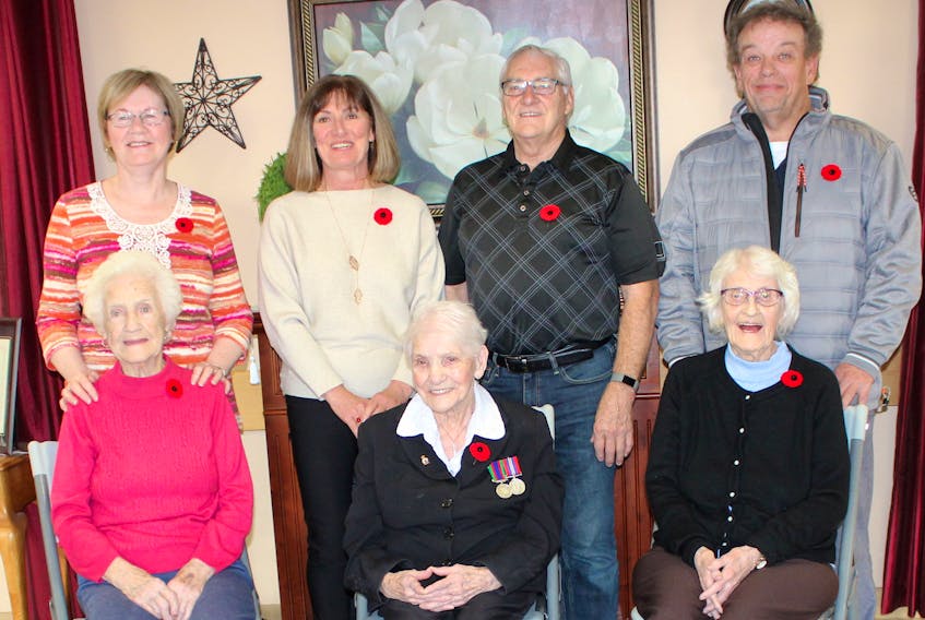 In front, from left, Mary (Mayme) MacSween, Christine Aucoin and Sarah Belle (Sadie) Morrison, all Second World War veterans, in the foyer of Taigh Na Mara long-term care facility in Glace Bay with their children on Oct. 29. The three women, who are all residents of the nursing home, served different roles during the war and were part of the influx of women who joined up after the Canadian government made it legal for them to enlist in 1941. With them are, back row from left, MacSween's daughter, Anne MacDougall; Aucoin's daughter, Patrice MacVicar and son Brian Aucoin;, and Morrison's son, Alex Morrison. NIKKI SULLIVAN/CAPE BRETON POST
