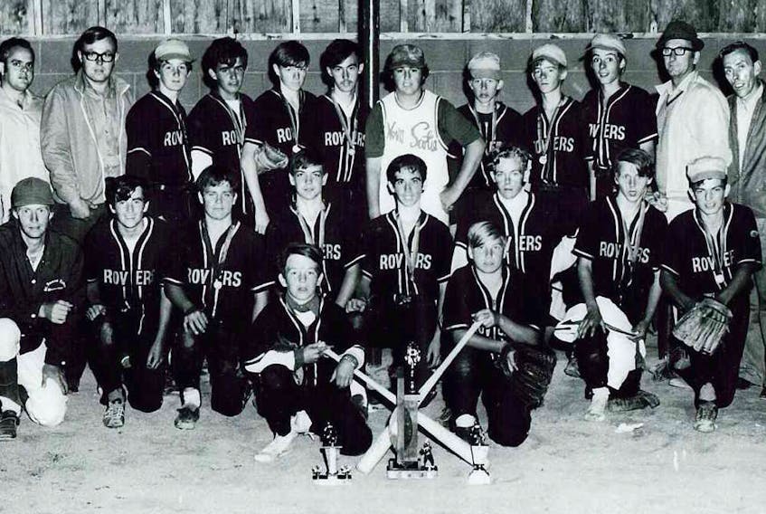 The 1971 New Waterford Kinsmen Rovers are pictured with the Cape Breton, provincial and Eastern Canadian championship trophies. The team captured the Eastern Canadian title with an 8-0 win over Montreal in Moncton, N.B. Front row, from left: Stephen Walker and Glen Hutchinson. Middle row, from left: Lowell Cormier (coach), Gary MacPherson, Elmore Cann, Charlie MacLellan, Kevin Kennedy, Bruce MacKenzie, Kevin Pastuck and Roger MacIsaac. Back row, from left: Blaise Poirier (assistant coach), Kinsmen reps Daniel Poirer and Gordon Roach, Stephen (Ness) Timmons, Bradley Nicholson, Stepehn Lee, Bonny MacKenzie, Greg Hawley, Wayne Detienne, George Campbell, Ricke Langer, managers Leo Kennedy and Fabe Sudworth snd supporter Harold Hawley.
