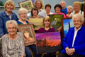 Well-known Cape Breton artist Marie Moore, centre, is shown surrounded by students from her Wednesday morning art class, some showing their first paintings done under her instruction. After 50 years of teaching, Moore is retiring from teaching but will continue painting. Shown here sitting in the front row, left to right, are Josie Matheson, Marie MacDonald-Campbell, Moore showing the latest piece she’s working on, and Kathleen McIntosh; standing, left to right, are Barb Mercer, Lois Vanderlinden, Laura Mercer, Janet Hawthorne, Debbie Lynn Kennedy, Tom Harvey, Elaine Roach and Debbie Ann Kennedy.