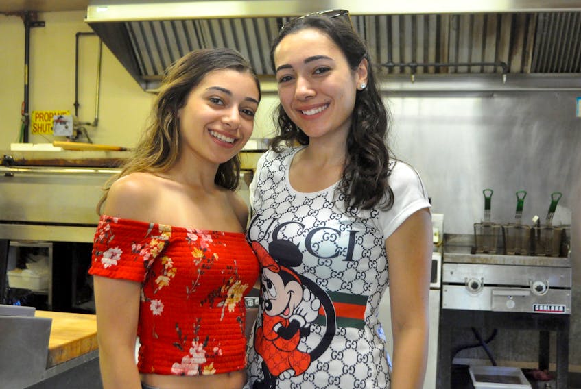 Mary and Nicole Rabahi say the hottest part of working at their family-owned Richie’s Pizzeria is when both the oven and fryer are on.