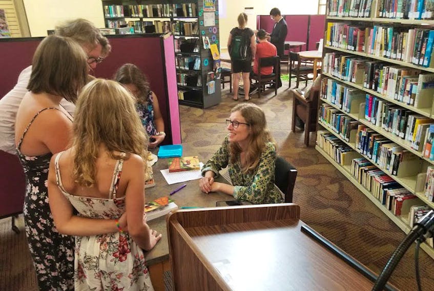 Hope Dalvay signs books during the launch for 'Welcome to Camp Fill-in-the-Blank,' earlier this summer in Charlottetown, P.E.I.