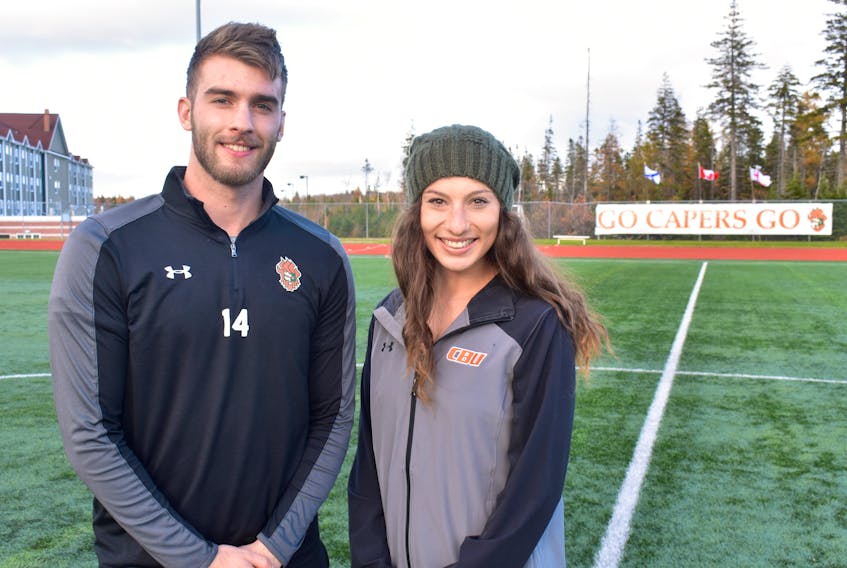 Jesse MacIntyre, left, and Becky Hanna of the Cape Breton Capers men’s and women’s soccer teams stand on the field at the Cape Breton Health Recreation Complex on Wednesday. The local soccer players will play in front of family and friends this weekend when the Capers host the Atlantic University Sport Championships, beginning Thursday in Sydney.