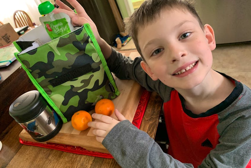 At the age of six, Levi Hart is already an accomplished lunch packer. He’s making sure to add a few clementines to his bag.