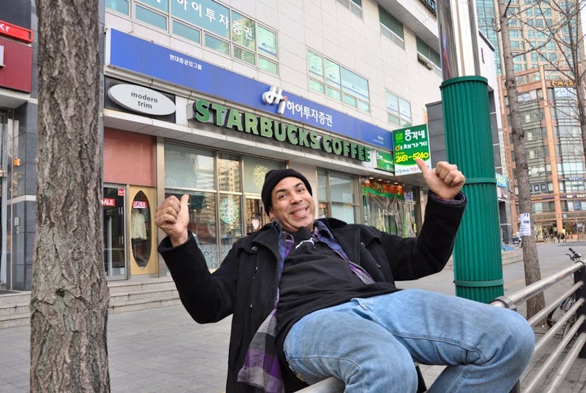 A man who goes by the name Winter poses in front of a Starbucks in Seoul, South Korea. In September, his mission to get a coffee from every one of the chain’s locations led him to Sydney.