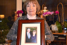 Norma Silverstein holds a photograph of her parents at her home in Albert Bridge on Wednesday. Silverstein, whose father died recently of septic shock caused by bedsores, has complained to the province that a nursing home left him in a wheelchair for eight hours a day.