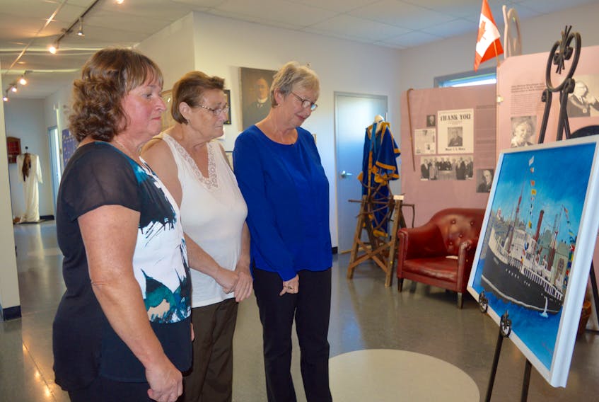 From left, Cassie Melnick, Kathleen Zegray and Nancy Kendall look at a painting of the S.S. Caribou, which sank on Oct. 14, 1942 after being torpedoed by a German U-boat, at the North Sydney Historical museum on Friday. A memorial service was held at the museum on Friday to honour the 75th anniversary of the marine tragedy. JEREMY FRASER/CAPE BRETON POST