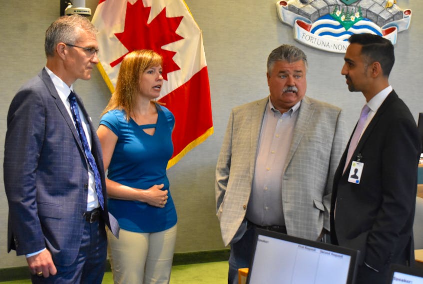 Grant Thornton accounting firm representatives John MacNeil, left, and Ricky Soni, far right, chat with CBRM chief financial officer Jennifer Campbell and CBRM councillor and chair of the viability study steering committee Darren Bruckschwaiger, prior to their presentation of the final report of a study on the future viability of the cash-strapped municipality. Local officials say the report confirmed what they already knew, that being that the municipality is fast heading down the road toward financial ruin and is essentially unsustainable under present conditions.