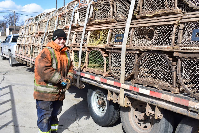 The first day of spring may be Wednesday, but that didn’t make Monday any warmer for Clarence Hill who made sure he was bundled up when he was called outside to deal with a problematic tire on trailer being used to transport lobster traps. While temperatures were just shy of zero, the gusting wind made it feel much cooler as Hill could attest to while he worked in the parking lots outside the shop. The Prince Edward Island-built lobster traps were on the way to Lingan when truck driver and trap seller Mark Hackett pulled into the tire shop after noticing an issue while on the highway.