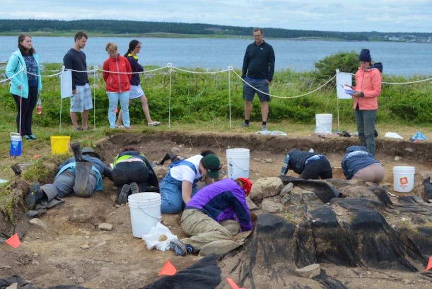 Bioarchaeologist students from the University of New Brunswick are seen excavating a burial site at Rochefort Point at the Fortress of Louisbourg on Friday. The university and Parks Canada have partnered to save the site from coastal erosion and better understand life in Louisbourg in the 1700s.