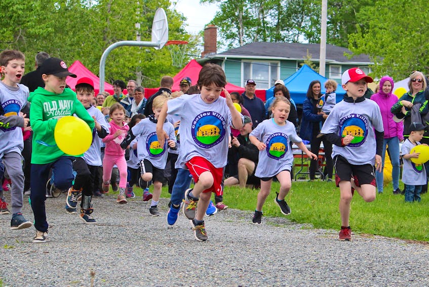 Keelan Buckley, 7, from left, keeps an eye on eight year olds Landon MacArthur and Ronan MacLean as they race to the front of the pack during the kids fun run in Cantley Village on Sunday during the grand opening of the neighbourhood's new accessible playground. Over four years, the Cantley Village Recreation Association raised over $225,000 for the playground. About 150 people showed up to the grand opening, which also included a barbeque.