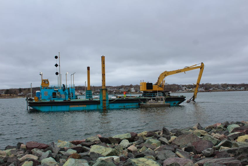 Crews dredge Sydney harbour in front of the Portside Restaurant, on April 22. The dredging started up this week and Cape Breton Regional Municipality engineering department says they are currently focusing on finishing this area, south of the existing dock, before moving on to the location of the new one. The pipe piledriving is “progressing as expected” said Cape Breton Regional Municipality spokeswoman Jillian Moore, who confirmed 26 of the 83 piles have been completed. Also finished are two new land-based bollards (one to the north and one to the south of the existing dock). These docks and the dredging at the south end of the existing dock will mean larger cruise ships can use the current berth this summer.