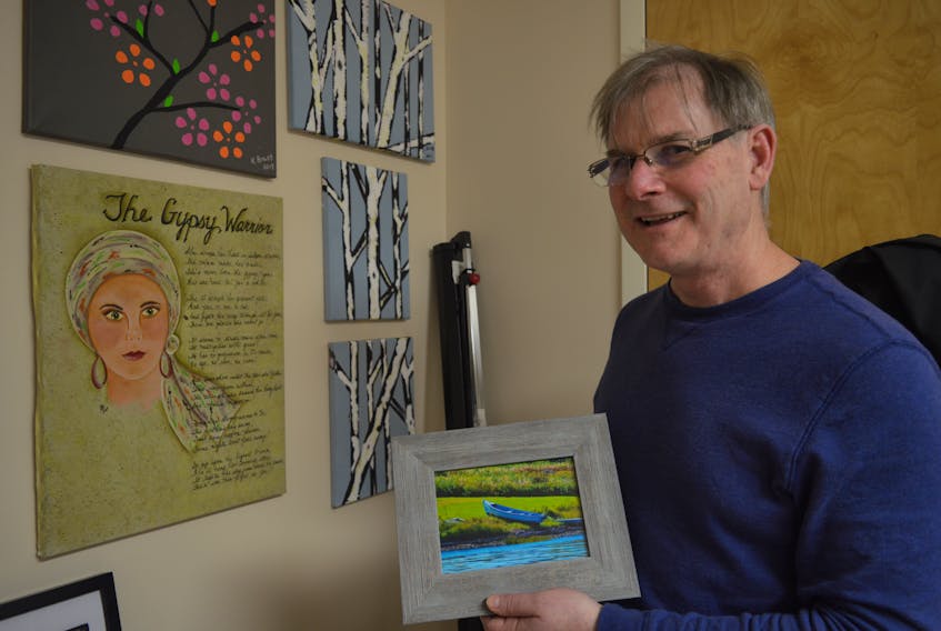 Tom MacNeil, a social worker at the Cape Breton Cancer Centre, stands in his office, shows off some of the art that was made during some art therapy workshops offered through the centre. He is the one who pushed to start the Cape Breton Cancer Fund and sees first-hand how the fund helps people battling cancer.