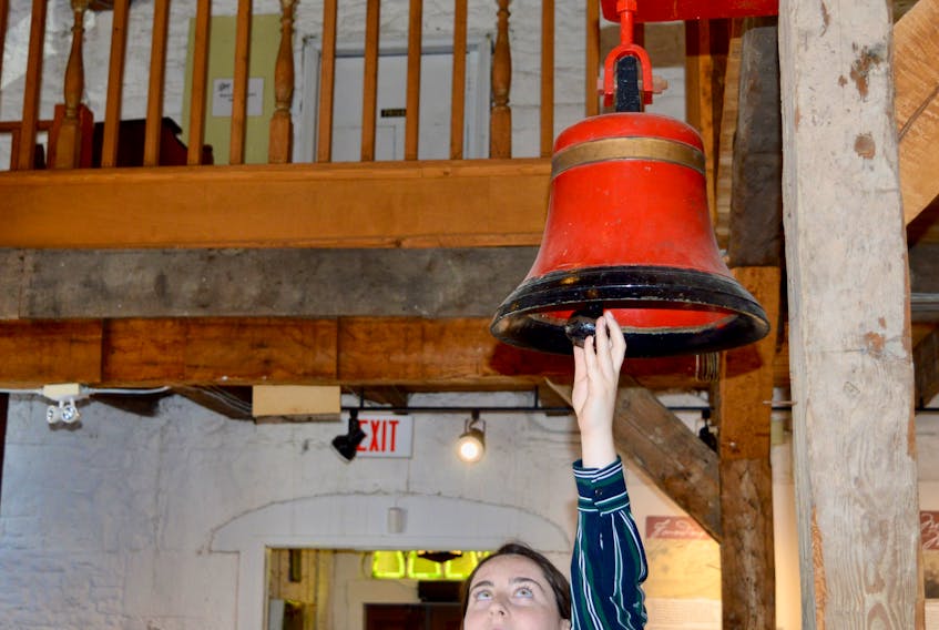 Breagh MacDermid shows the market bell at St. Patrick’s Church Museum in Sydney. Legend has it, if the market bell rings three times, the door to the belfry upstairs will open on its own. MacDermid says it has happened from time to time.