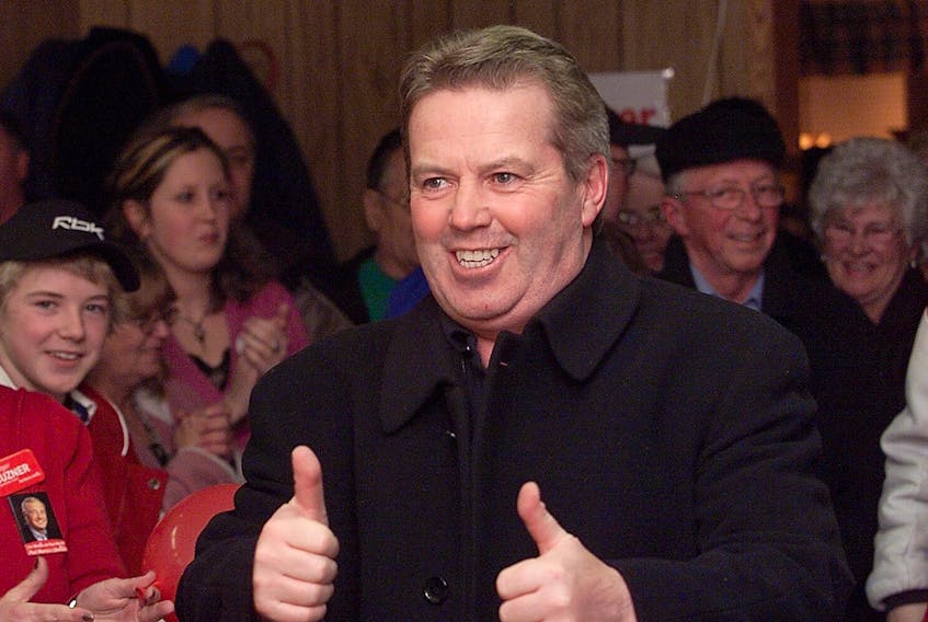 Rodger Cuzner gives the two thumbs-up sign as he enters his campaign headquarters in Glace Bay surrounded by his campaign workers on Jan. 22, 2006.