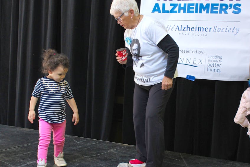 Retired teacher Sandra Kelly shows two-year-old Addilynn Lyon how to do the Hokey Pokey while waiting for the start of the Walk for Alzheimer’s on May 5 at Centre 200. Kelly was part of a team walking for her mother Evelyn Kelly and Lyon, from Halifax, was there with her mother Rachael Lyon who is a volunteer with the Alzheimer Society of Nova Scotia. The walk in Nova Scotia started in 2006 after Jigger Mott, a man who had walked across the province raising awareness for seniors’ issues, asked them to take over his initiative. More than 200 people participated in the Sydney walk and all money raised locally stays in Cape Breton to help provide programming, education and support for people with Alzheimer’s and dementia and their families.