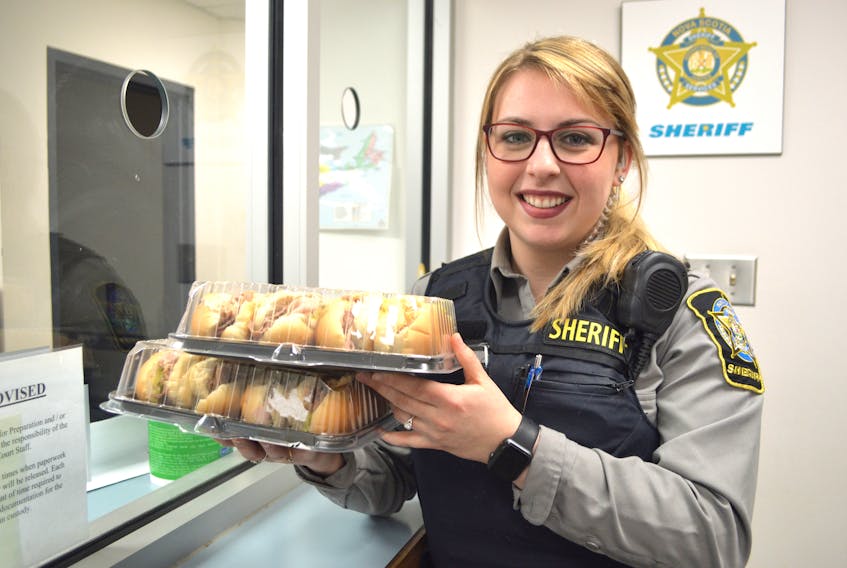 Jessica Finney, 23, a deputy sheriff at the Sydney Provincial Court, holds some subs from Sobeys in Sydney while recently preparing to deliver them to individuals in custody at the courthouse awaiting court appearances. The province provides subs and a drink to those in custody at the courthouse over lunch time.