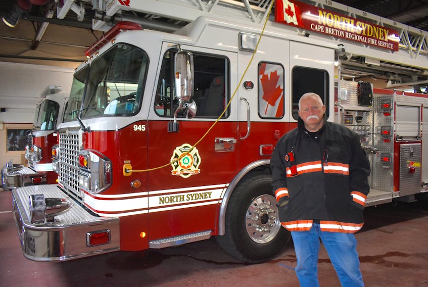 Lloyd MacIntosh, fire chief of the North Sydney Volunteer Fire Department, stands near one of the fire department’s newest trucks. The majority of the department’s fire apparatus are newer model vehicles.