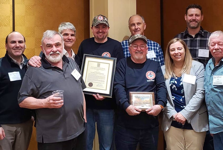 Members of the Port Morien Wildlife Association pose with the Nova Scotia Sportfish Development Award and workers with the Nova Scotia Department of Fisheries and Aquaculture, during the recent Nova Scotia Federation of Anglers and Hunters Convention in Halifax. From left, front, John Kennedy, PMWA, Stan Peach, PMWA, Amber Creamer and Mike McNeil; back, Stephen Thibodeau, Jason LeBlanc, Alan McNeil, Jeff McNeil, president of the PMWA, Darryl Murrant, Jamie Vallis, and William Peach, PMWA.