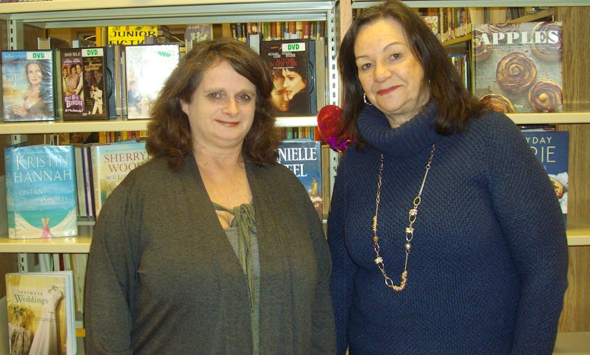 Ruth Anne Gillis, left, and Debbie Poditz are two of the four librarians at the Wilfred Oram Centennial Library in North Sydney.