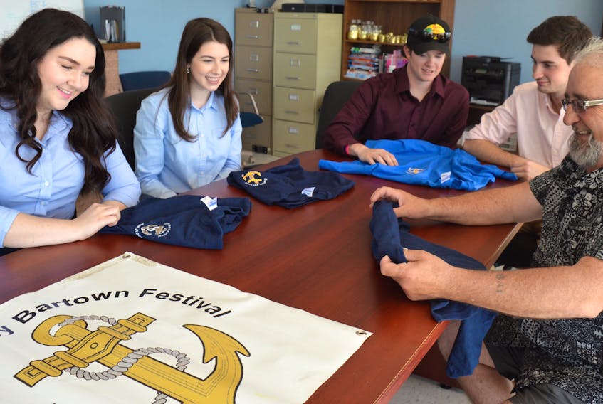 Genevieve Andrea, from left, Andrea MacNeil, Glenn MacInnis, Dylan McLean and Bill Weatherbee display some of the Bartown Festival T-shirts in this 2017 Cape Breton Post file photo.