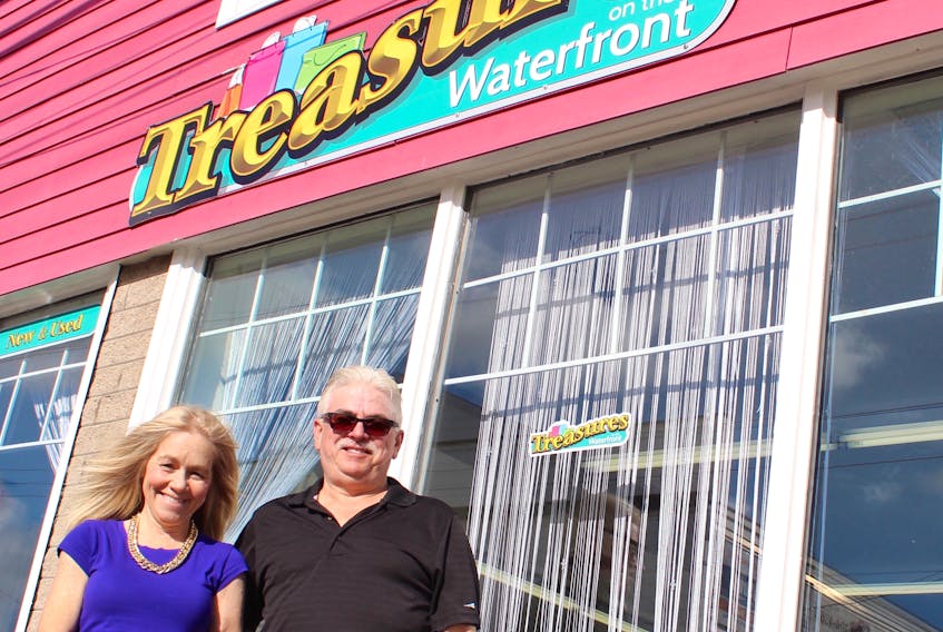Valerie and Alex Pendergast stand outside their resale and consignment shop, Treasures on the Waterfront. The Commercial Street boutique will host its grand opening Tuesday from 11 a.m. to 8 p.m.