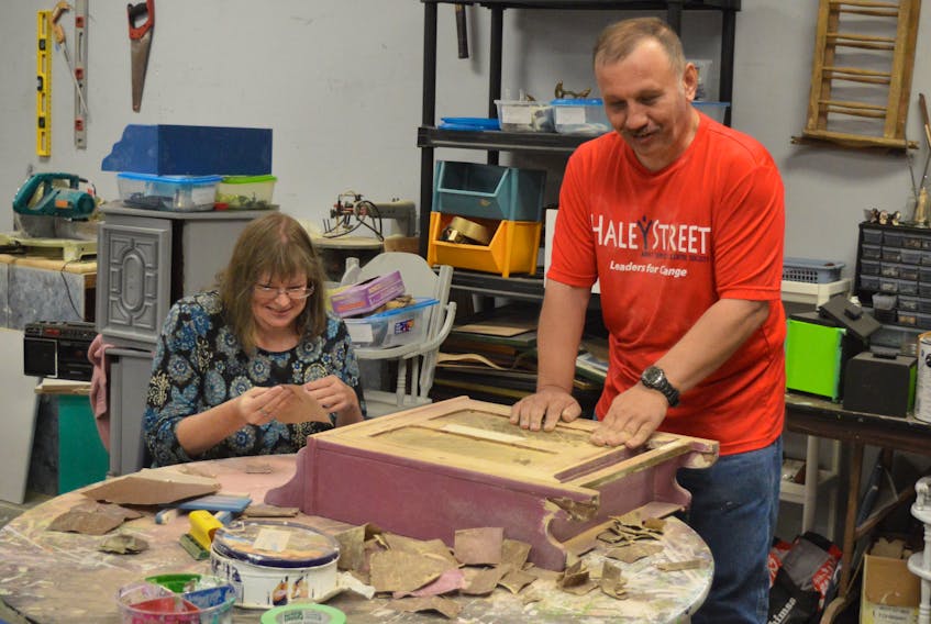 Haley Street Adult Services Centre clients Holly Boutilier, left, and Paul Mitchelitis work at restoring an old cabinet. The pair is employed at the centre’s recently established Re Find store in the North Sydney Shopping Mall. The outlet employees centre clients, who transform old, unwanted furniture and items into newer, fresher products. The store also offers a selection of second-hand clothes and arts and crafts.