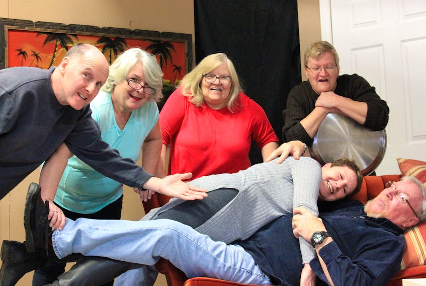 Actors involved in the Port Morien Players’ upcoming dinner theatre, “Sandy Toes and Salty Kisses,” take a break during rehearsals earlier this month. From left, standing, Alan Nicholson,  Jean MacLean, Myrna Murphy, Clara MacIntosh and, on the sofa, Brenda McDonald and Ron Peach. Also in the cast but missing from the photo is Todd Pictou. CONTRIBUTED PHOTO/ PORT MORIEN PLAYERS