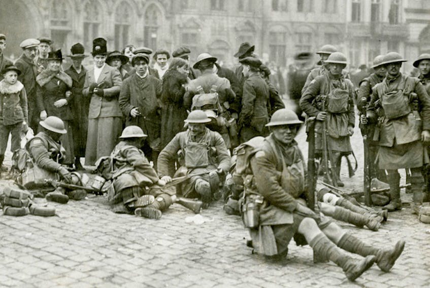 Canadian soldiers and civilians at Mons, shortly after the armistice was signed on Nov. 11, 1918. Did the armistice end conflict and suffering in Europe and beyond? Not at all, explains Sean Howard. CANADIAN CENTRE FOR THE GREAT WAR