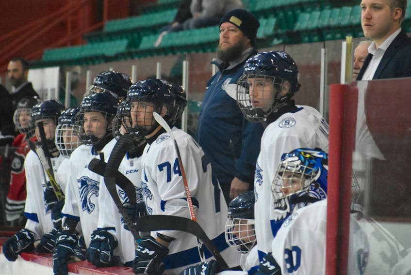 Members of the Sydney Academy Wildcats watch the play during a game against the Glace Bay Panthers during Panther Classic action at the Canada Games Complex on Dec. 6. Sydney Academy will not host the Blue and White tournament this year.