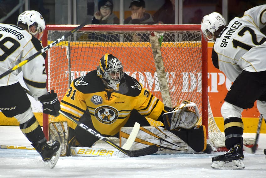 Kevin Mandolese of the Cape Breton Screaming Eagles, middle, makes a save on Sullivan Sparkes of the Charlottetown Islanders, right, as Cole Edwards of the Islanders looks for the rebound during a Quebec Major Junior Hockey League game earlier this month in Sydney. The Screaming Eagles and the Islanders will open league playoffs against each other on Friday in Charlottetown, P.E.I. Jeremy Fraser/Cape Breton Post