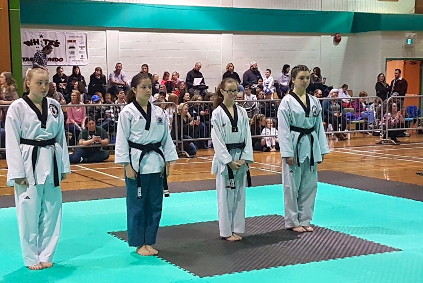 Island Martial Arts hosted its 14th annual Cape Breton Taekwondo Championship on April 6 at Whitney Pier Memorial Middle School. More than 125 competitors from across Nova Scotia participated, while hundreds of spectators visited the school’s gym for the event to see competitors take part in poomse, sparring and board breaking. In the picture, from left, Emily Reid, Jenna MacLean, Lexi Hillier and Bailee Miller wait for their results in the black belt poomse competition. Photo Contributed/Angie MacDonald