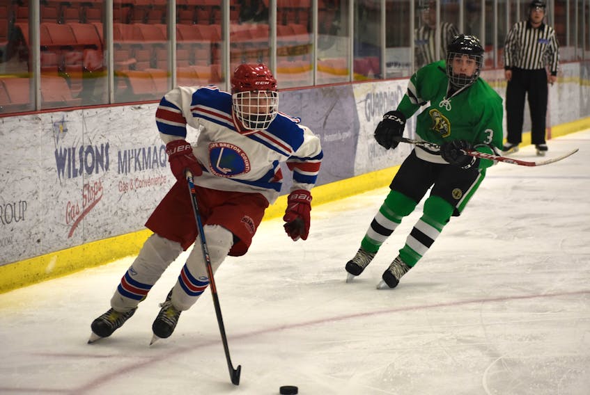 Colby McCarron of the Cape Breton County Islanders, left, carries the puck during a Nova Scotia Midget ‘AA’ Provincial Championship game against the Chebucto Atlantics on April 5 at the Membertou Sport and Wellness Centre. McCarron was named the Cape Breton Hockey League rookie of the year for the midget ‘AA’ division.