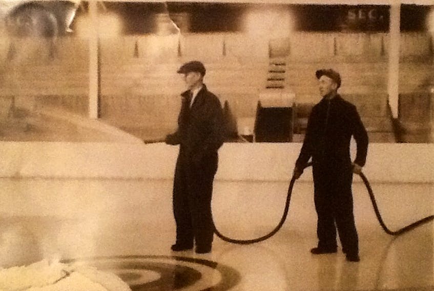 Joe Poirier (left) and Rufus Foote flooding ice at Sydney Forum in 1940s. Note the center ice rings. (Courtesy of Shirley Mombourquette/photographer unknown)