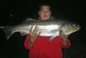 Skyler Jeddore with a Bras d’Or striper caught in January near Benacadie. CONTRIBUTED/SKYLER JEDDORE