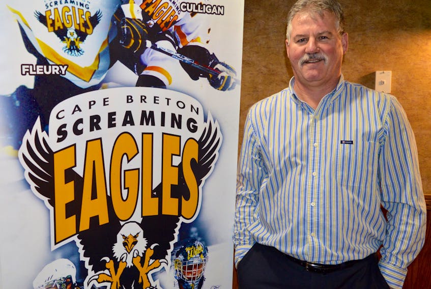 Cape Breton Screaming Eagles president Gerard Shaw stands near the Screaming Eagles logo at the local major junior team’s business office. The team has made a number of changes behind the scenes over the past month.