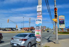 A utility pole littered with signs on Prince Street in Sydney. Dist. 12 Coun. Jim MacLeod and Dist. 4 Coun. Steve Gillespie are hoping to pass a motion to create a new bylaw regulating signage at today's Cape Breton Regional Municipality council meeting. Sharon Montgomery-Dupe/Cape Breton Post