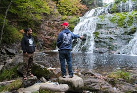 Fabian Henry, left, talks about Egypt Falls with his father Fabian Henry Sr. on Sept. 29. Henry is an army veteran who recently bought 130 acres in Pipers Glen, including the falls, to build a holistic retreat primarily for veterans suffering from PTSD and other mental illnesses. Henry has also purchased Chimney Corner beach and a lot in Inverness overlooking the fifth hole of Cabot Links.